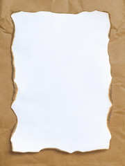 A blank white paper with burnt edges, framed by a crumpled brown paper background.