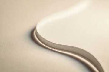 Obraz premium A distant view of a drawing featuring a long pale line gracefully curving across a smooth surface, illuminated by soft light