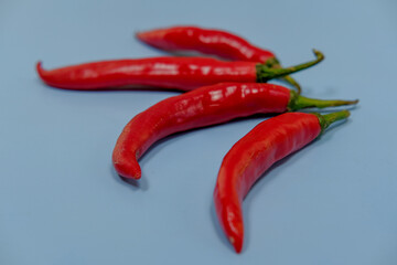 Red peppers on a light blue surface