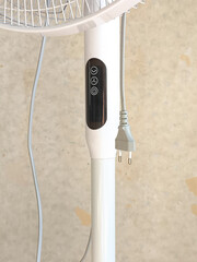 Modern electric fan on wooden table in living room. Space for text