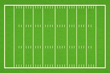 American football field with green grass and ball placed on the field ready for play