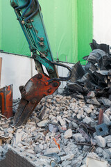 Demolition site with excavator and rubble