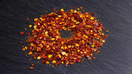 crushed dry chili flakes on surface.ai 