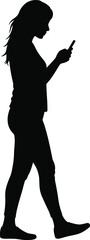 Silhouette of a woman walking and using her mobile phone isolated on white background