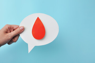 Blood Donation Awareness Hand Holding Speech Bubble with Blood Drop