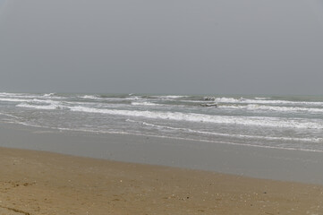 Murky waters of Rimini beach with overcast Sky, Rimini