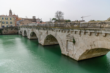 Fototapeta premium Ponte di Tiberio – Ancient Roman Bridge over Marecchia River in Rimini, Italy