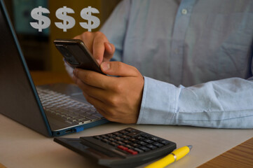 Businessman using smartphone and laptop in office. Man scrolls social media, checks email, manages...