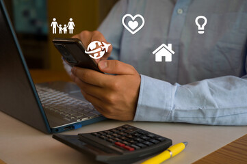 Businessman using smartphone and laptop in office. Man scrolls social media, checks email, manages...