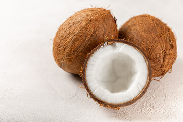 Set of fresh whole and half coconuts and slices on wooden background. Coconut flakes. Vegan....