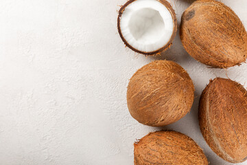 Set of fresh whole and half coconuts and slices on wooden background. Coconut flakes. Vegan....