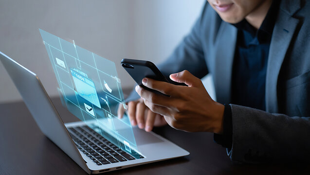 Man using smartphone with digital interface overlaying laptop screen showing file management icons