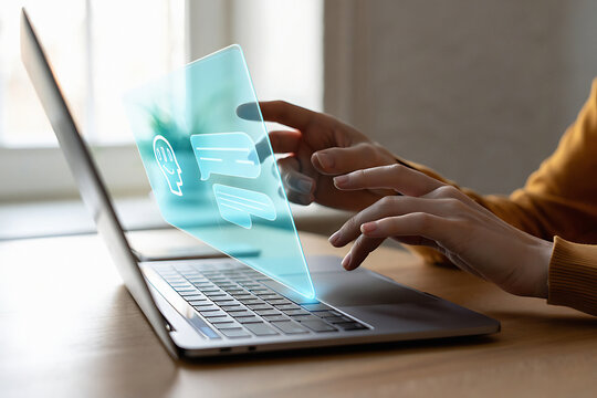 Person using laptop with ai interface showing chat bubbles and human head icon on transparent screen