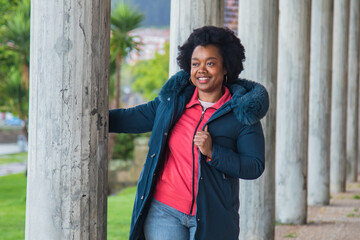 young woman in winter clothes enjoying the park