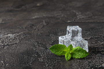 Mint and ice on texture background. Green fresh mint and ice cube. Mint leaves, ice cube and water...