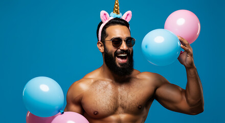 A playful and charismatic muscle unicorn, embodied by a muscular bearded man, celebrates with colorful balloons against a vibrant blue studio background.