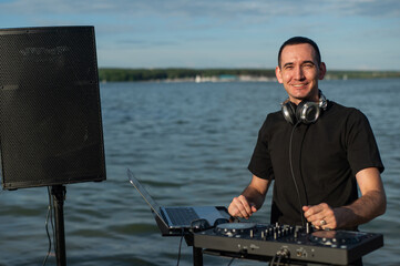 Portrait of a DJ on the river bank. 