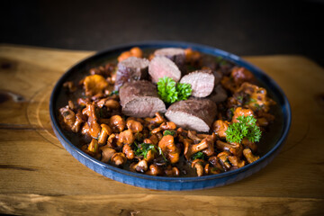 roasted chanterelles and filet from venison with fresh herbs out the garden 