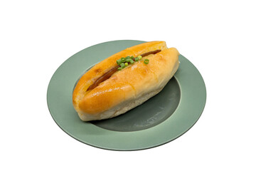 Savory Delight: A golden-brown bun rests gracefully on a green plate, filled with a savory filling,...