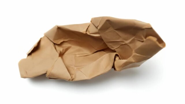 A crumpled, light-brown paper ball, irregularly shaped, showing deep creases and folds, isolated on a stark white background