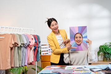 Young Asian woman doing personal color diagnosis by Face frames Color Season Kit for determining...