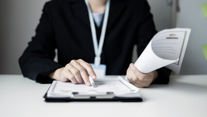 Business woman employer holding resume hiring recruit looking cv resume to hire candidates, analyzing information before job interview. Recruitment concepts