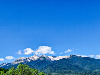 high mountain landscape with blue sky and clouds