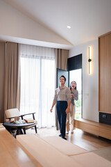 Happiness in new home. Happy married couple is having fun, hugging and sincerely rejoicing over...