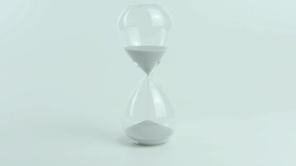 Time Compliance written on a yellow sticky note placed on an hourglass against a white background. Represents meeting time-related rules, standards, and deadlines