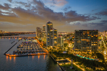 Twilight over Miami skyline and marina. Luxury yachts glowing in the Miami harbor. Sunset cruise...