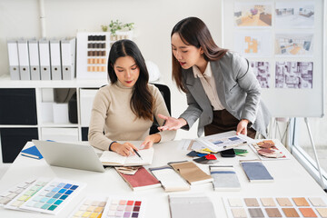 Interior design, two working colleagues designers, or decorator and client choosing finishing...