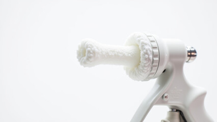 Glue gun applying adhesive onto acoustic insulation for wall installation test