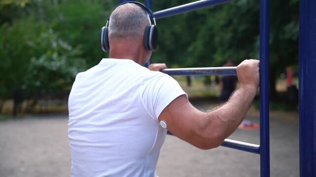 Man with glucose monitoring sensor resting after training 
