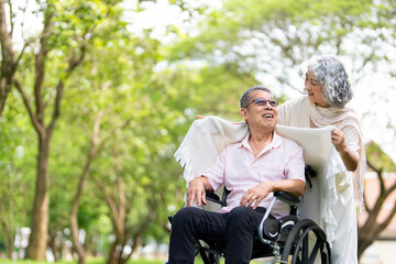 Woman and her husban on the wheelchair going out. concept about disable and people.