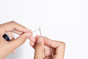 Hands Holding Needle and Thread for Sewing and Housework Tasks