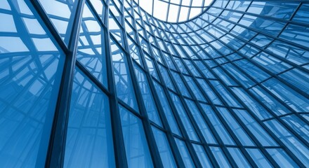 Modern architectural design featuring a glass structure with intricate geometric patterns under a clear sky