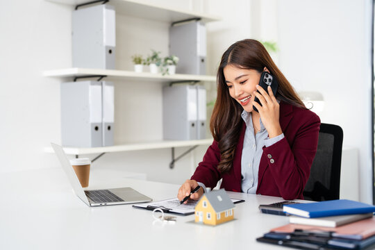 smart real estate agent professional making business call talking on mobile phone with customer for signing rental lease contract in office, home loan contract, buying house, real estate concept