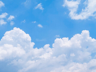 Soft white clouds with a beautiful blue sky in the morning light. Soft white clouds float in the clear blue sky. Clear blue sky, bright spring, soft sky gradient.