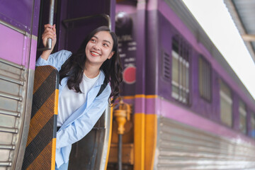 Young woman boarding train, embarking on new journey