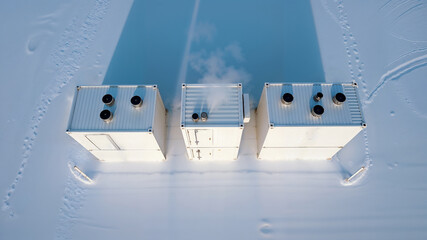 Containers in the snow. An aerial top-down view of three industrial energy storage containers in a remote, snowy landscape for off-grid power.