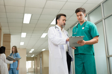 Major Caucasian man doctor with Caucasian man medical student working at hospital	