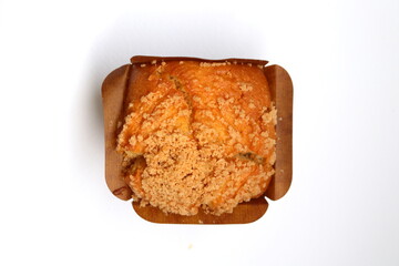 Top view baked muffin in square shape brown paper cup on white background.