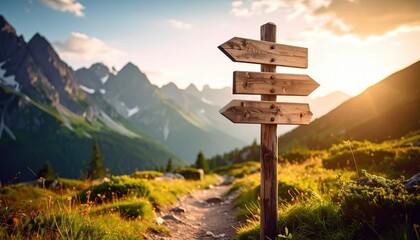 Wooden signpost in a mountain valley at sunset