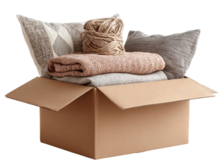 Moving day essentials cozy blankets and yarn in a box home. Isolated on transparent background, png.