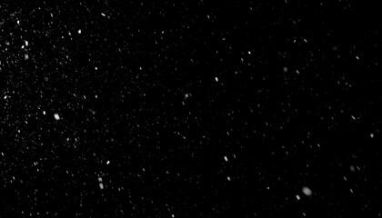 Abstract black background with scattered white specks