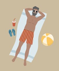 Gray haired man lying on the beach sunbathing.