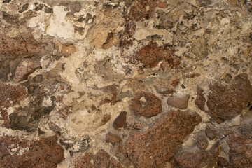 Old rustic stone wall showcasing varied textures in natural light during afternoon hours