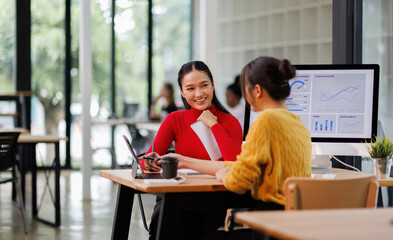 Financial team Business women analyze the graph of the company's performance to create profits and...