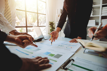 Young colleagues discussing business and price chart analyzes business people on the table great in...