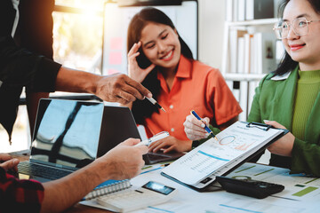 Brainstorming of young modern group. Team meeting to achieve goal. Business people discussing finance business and analysis. Teamwork concept in modern office. Calculating personal tax for client.